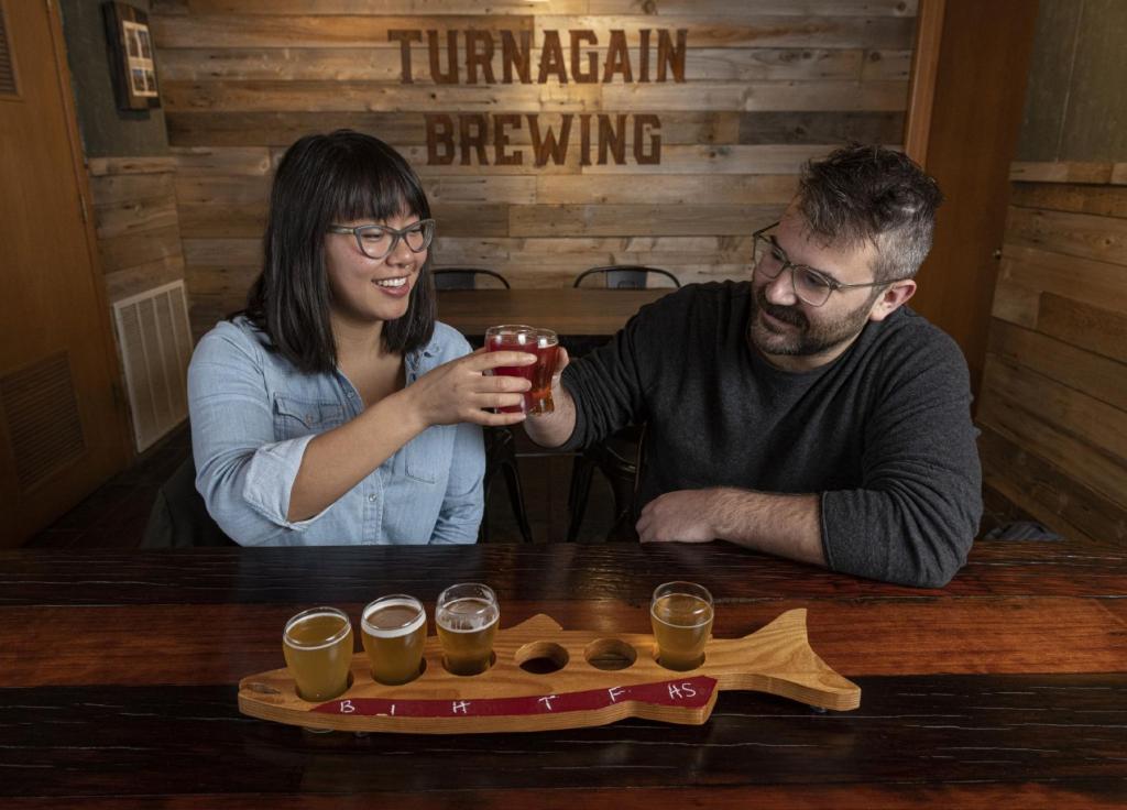 A couple enjoys a beer flight at Turnagain Brewing in Anchorage