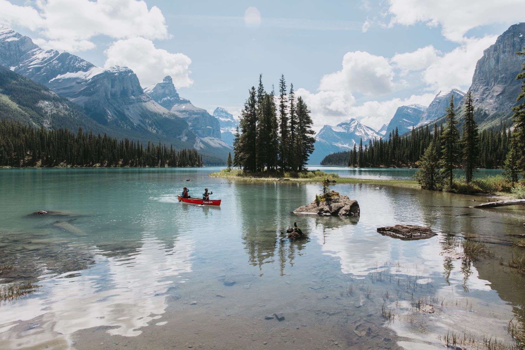 Kayakers on a lake with mountains in Alberta