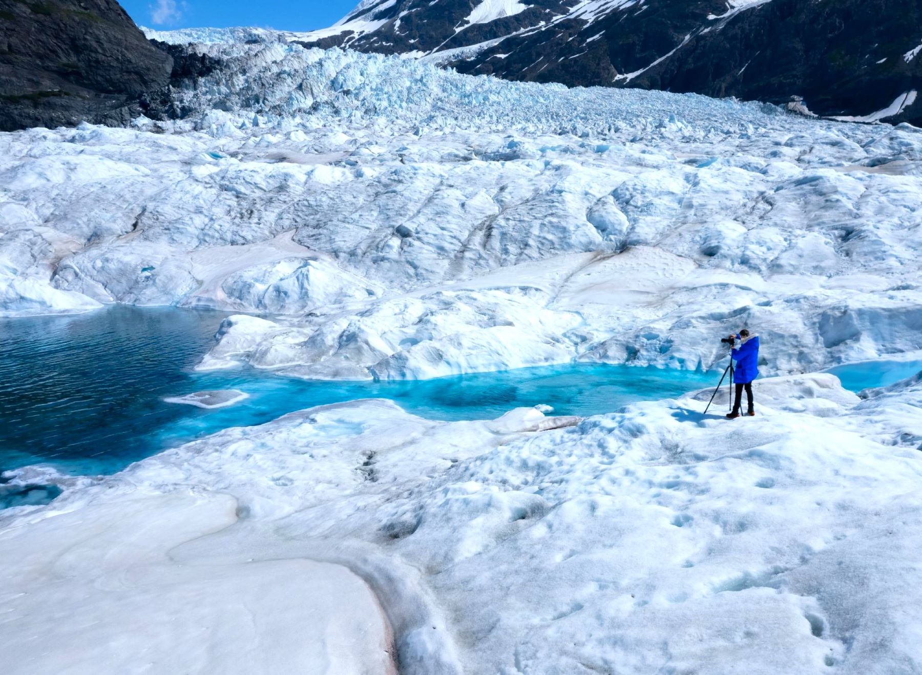 Man taking a photo on a glacier