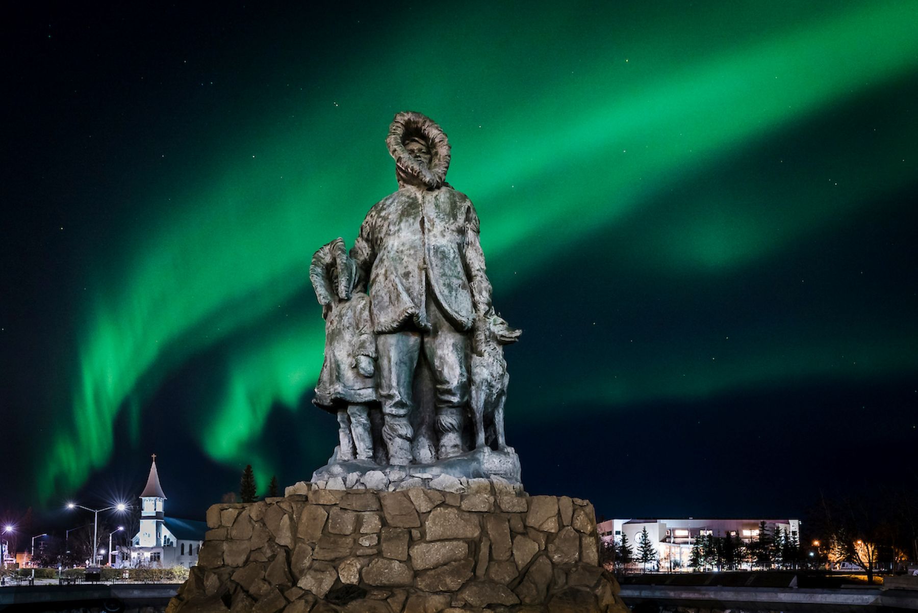 Northern lights behind a statue in downtown Fairbanks
