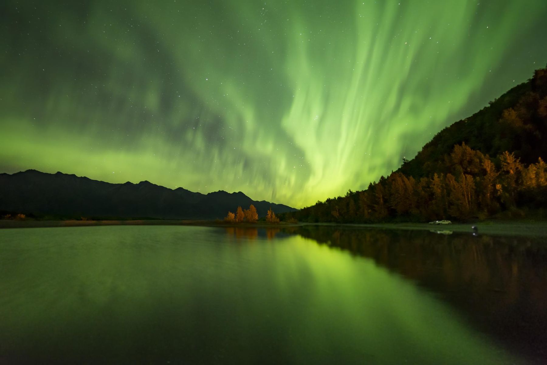 Northern lights over a lake in the fall