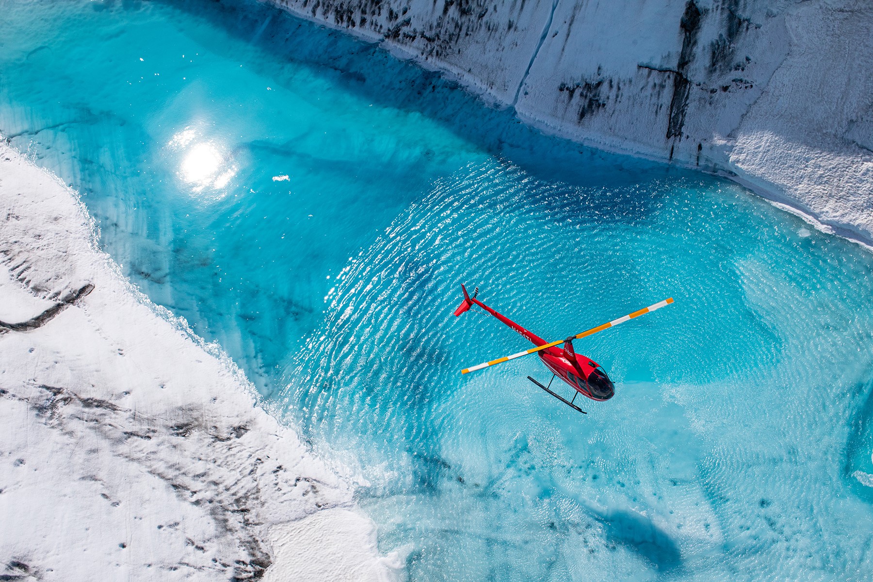 Overhead shot of helicopter and glaciers in Alaska