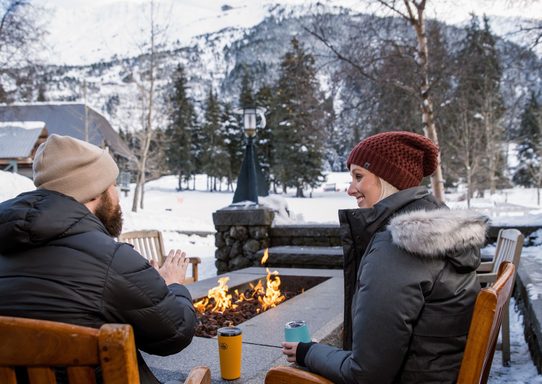Two people by the fire at Alyeska resort