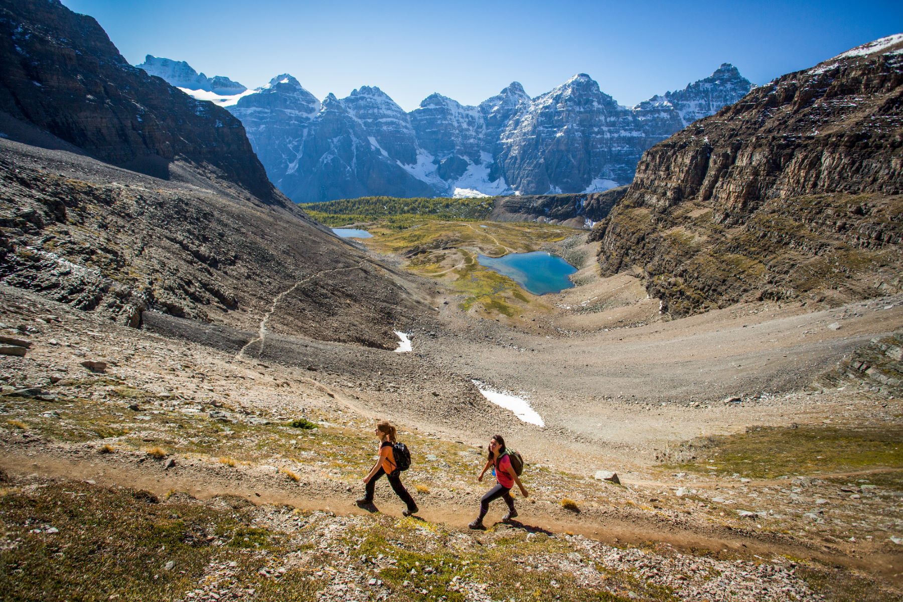 People hiking through an alpine valley at Sentinel Pass in Banff National Park, Alberta
