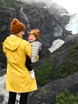 Woman hiking with baby in Kenai Fjords National Park