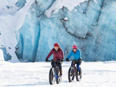 Fat biking in the snow near a blue glacier in Anchorage