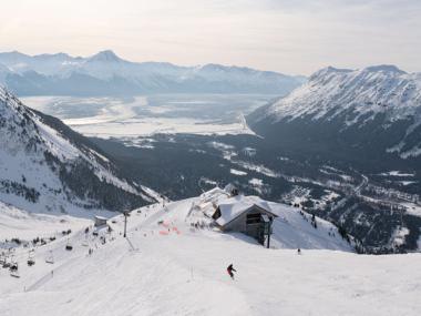 Person skiing down a snowy mountain in Alaska