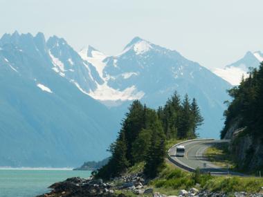 Driving on Alaska's Golden Circle with mountains in the background