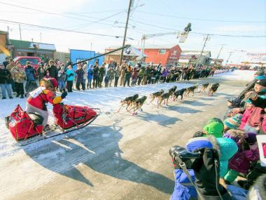 Dog musher finishes the Iditarod Sled Dog Race in Nome Alaska