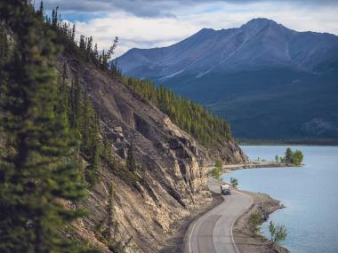 Driving the Alaska Highway along Muncho Lake, BC