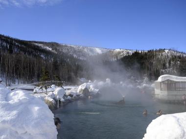 People enjoy Chena Hot Springs on a sunny day in winter.