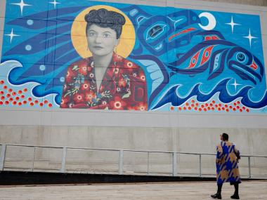 A woman views the Elizabeth Peratrovich mural in Juneau