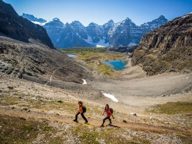 People hiking through an alpine valley at Sentinel Pass in Banff National Park, Alberta