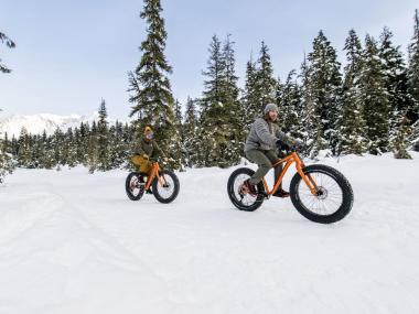 Two people fat tire biking in Girdwood in winter