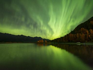 Northern lights over a lake in the fall