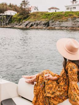 A woman enjoys the coastal view from a private cruise on Alaska's waterways