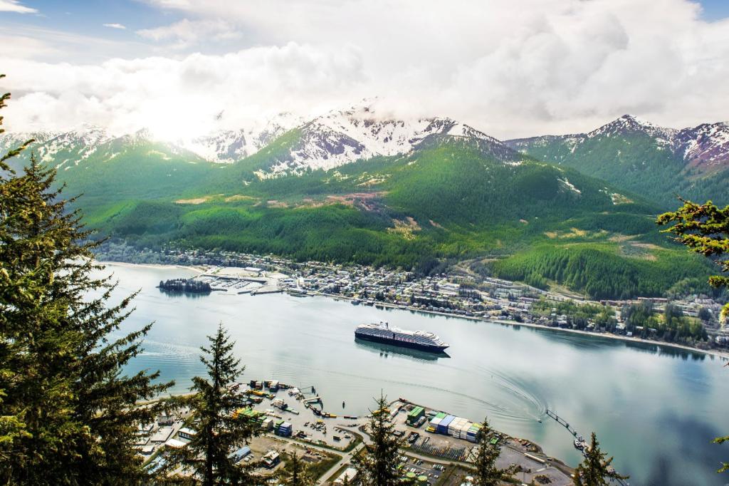 A cruise ship sails by the town of Juneau, Alaska