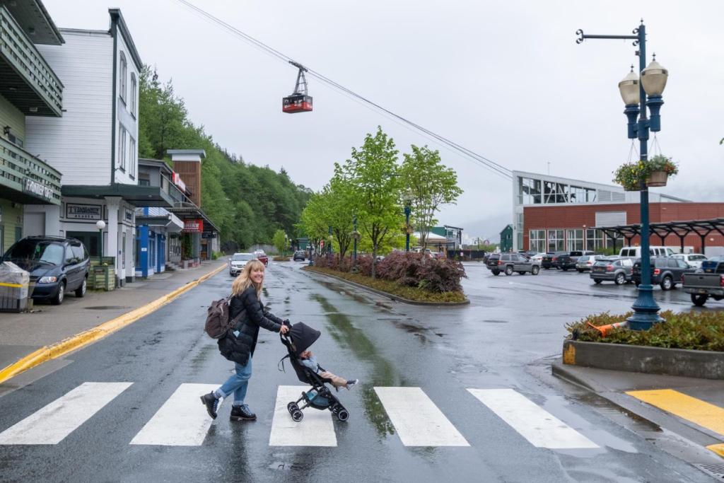 Mother pushing stroller under Mount Roberts Tramway in Juneau