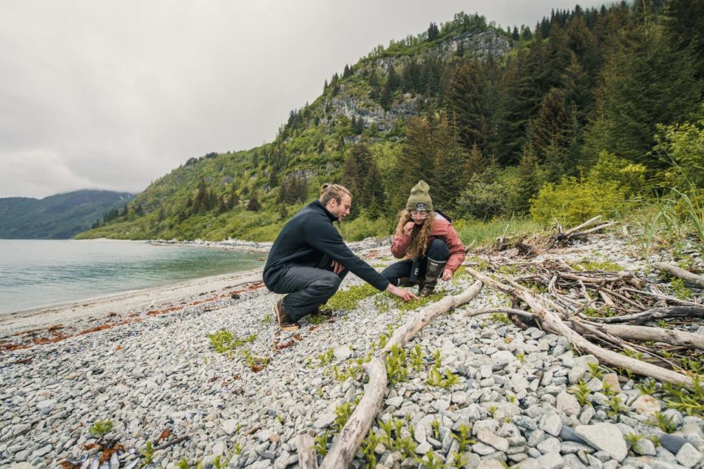 Two people exploring the beach in Glacier Bay National Park